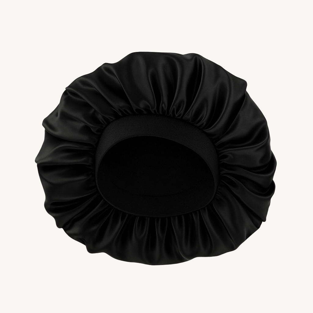 Black satin hair bun cover on a white background