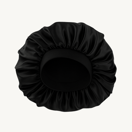 Black satin hair bun cover on a white background